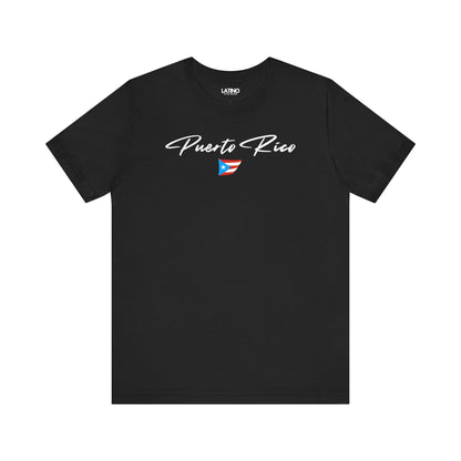 Black T-shirt with white Puerto Rico script lettering and small Puerto Rican flag graphic by Latino In Da House.