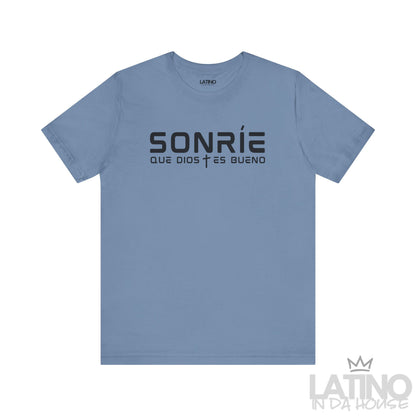 Sonríe Que Dios Es Bueno T-shirt in steel blue with modern black lettering and cross divider. Latino In Da House 